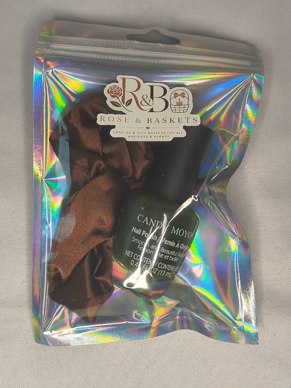 small gift bag of nail polish and a matching hair tie.